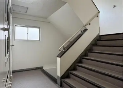 a staircase in a building with a window at -Katsura 207- 4 mins to Okubo Station in Tokyo