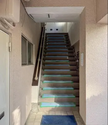 a staircase with blue and green steps in a building at -Katsura 207- 4 mins to Okubo Station in Tokyo