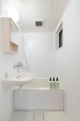 a white bathroom with a sink and a mirror at -Katsura 207- 4 mins to Okubo Station in Tokyo