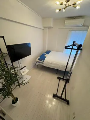 a bedroom with a bed and a television in it at -Katsura 207- 4 mins to Okubo Station in Tokyo