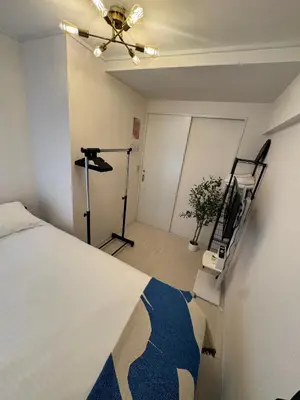 a bedroom with a bed and a treadmill at -Katsura 207- 4 mins to Okubo Station in Tokyo