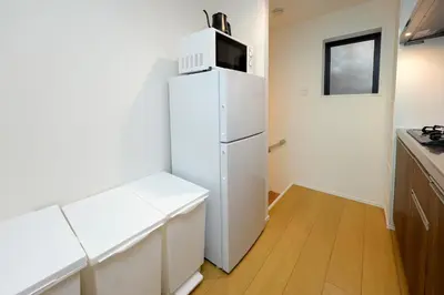 a white refrigerator with a microwave on top of it at monthly Oakville \u6839\u6d25 in Tokyo