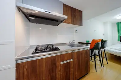 a kitchen with a sink and a stove top oven at monthly Oakville \u6839\u6d25 in Tokyo