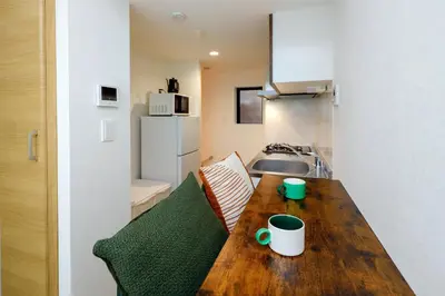 a small kitchen with a wooden table in a room at monthly Oakville \u6839\u6d25 in Tokyo