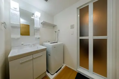 a bathroom with a toilet and a sink and a mirror at monthly Oakville \u6839\u6d25 in Tokyo