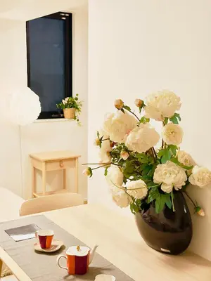 a vase filled with white flowers sitting on a table at Skytree Garden Hotel in Tokyo