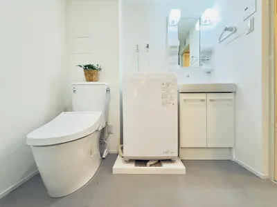 a white bathroom with a toilet and a sink at Skytree Garden Hotel in Tokyo