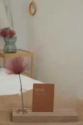 a flower in a vase on a table with a plaque at Skytree Garden Hotel in Tokyo
