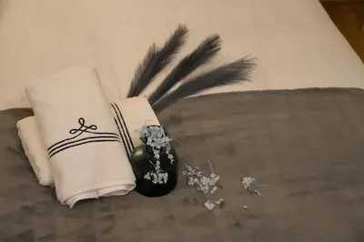 a couple of towels and flowers on a bed at Skytree Garden Hotel in Tokyo
