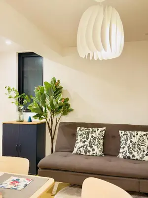 a living room with a couch and a table at Skytree Garden Hotel in Tokyo