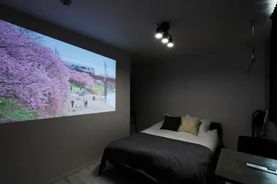 a bedroom with a large painting on the wall at Excellent Arbre in Tokyo