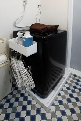 a black dishwasher in a room with a floor at Excellent Arbre in Tokyo