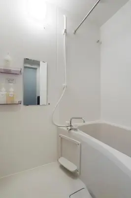 a white bathroom with a sink and a mirror at Excellent Arbre in Tokyo