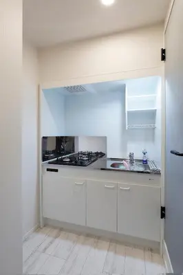 a white kitchen with a sink and a stove at Excellent Arbre in Tokyo