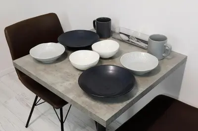 a table with four bowls and plates on it at Excellent Arbre in Tokyo