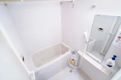 a small white refrigerator with a mirror in it at 504Room Kinshicho Station 5 min walk near Asakusa and Skytree 5th floor with balcony and good soundproofing in Tokyo
