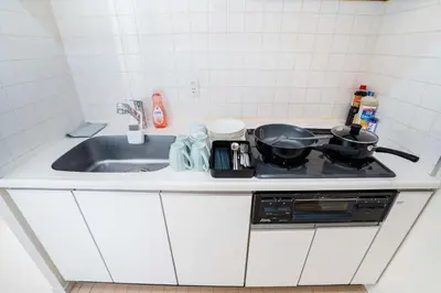 a kitchen counter with two pots and pans on a stove at 504Room Kinshicho Station 5 min walk near Asakusa and Skytree 5th floor with balcony and good soundproofing in Tokyo