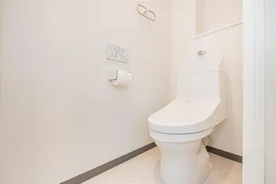 a white toilet in a bathroom with a toilet paper dispenser at JR\u5c71\u624b\u7dda\u5f92\u6b69\u4e94\u5206 ZAITO TOKYO NEST Hotel in Tokyo