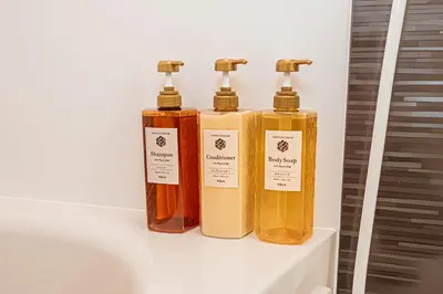 three bottles of soap sitting on a shelf at JR\u5c71\u624b\u7dda\u5f92\u6b69\u4e94\u5206 ZAITO TOKYO NEST Hotel in Tokyo