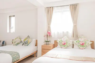 a bedroom with two beds and a window at JR\u5c71\u624b\u7dda\u5f92\u6b69\u4e94\u5206 ZAITO TOKYO NEST Hotel in Tokyo