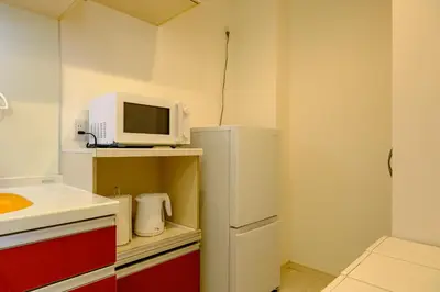 a kitchen with a white refrigerator and a microwave at Stellar inn - \u65e9\u7a32\u7530\u99c5\u304b\u3089\u5f92\u6b693\u5206- \u6700\u59277\u540d\u5bbf\u6cca\u53ef in Tokyo