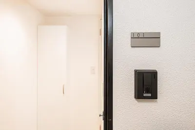 a door with a sign that reads on it at \u897f\u6b66\u65b0\u5bbf\u7dda\u5f92\u6b69\u4e09\u5206 ZAITO Shimoochiai Stay in Tokyo
