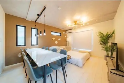 a dining room with a table and blue chairs at nishiotiai,shinjukustation12 minutes by train in Tokyo