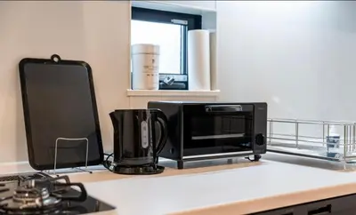 a microwave sitting on top of a kitchen counter at nishiotiai,shinjukustation12 minutes by train in Tokyo