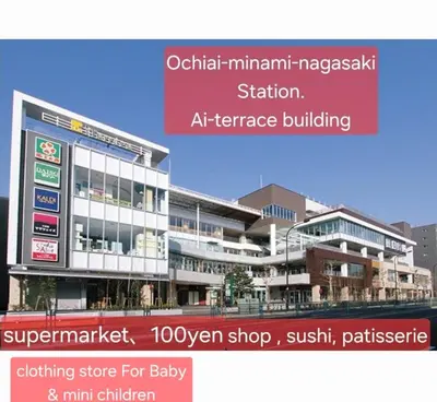 a rendering of an apartment building with a sign at nishiotiai,shinjukustation12 minutes by train in Tokyo