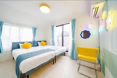 a bedroom with a large bed and a yellow chair at nishiotiai,shinjukustation12 minutes by train in Tokyo