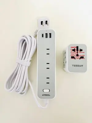 a nintendo wii game controller next to a charger at Cute Anime-Style Room Near Kinshicho Station in Tokyo