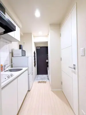 a white kitchen with a sink and a refrigerator at Cute Anime-Style Room Near Kinshicho Station in Tokyo