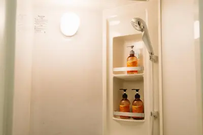 a bathroom door with three bottles of alcohol in it at SEADINERS VILLA AOYAMA Tokyo First Metropolis Villa Pool Sauna BBQ in Tokyo