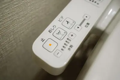 a remote control sitting on top of a table at SEADINERS VILLA AOYAMA Tokyo First Metropolis Villa Pool Sauna BBQ in Tokyo