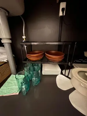 a shelf with two bowls and some green glasses at Villa TOKYO SHIMOTAKAIDO Nest in Tokyo