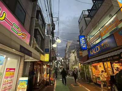 a group of people walking down a street with shops at Villa TOKYO SHIMOTAKAIDO Nest in Tokyo