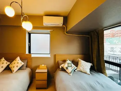 two beds in a small room with a window at \u30e9\u30a4\u30aa\u30f3\u30ba\u30d7\u30e9\u30b6\u65b0\u5bbf901 in Tokyo