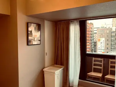 a bathroom with a washer and dryer next to a window at \u30e9\u30a4\u30aa\u30f3\u30ba\u30d7\u30e9\u30b6\u65b0\u5bbf901 in Tokyo