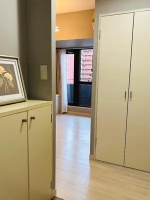 an empty living room with a door and a room with a wooden floor at \u30e9\u30a4\u30aa\u30f3\u30ba\u30d7\u30e9\u30b6\u65b0\u5bbf901 in Tokyo