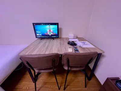 a wooden desk with a computer on top of it at Credo House Shin-Okubo in Tokyo