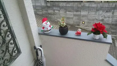 a shelf with a snowman and potted plants on it at Aila Room in Tokyo