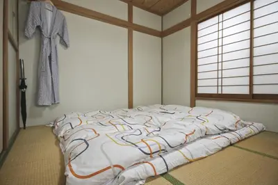 a bedroom with a large bed in a room at Aila Room in Tokyo