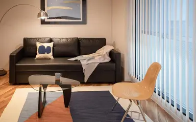 a living room with a couch and a table and chairs at Takinogawa-1ldk\u677f\u6865 KI0429 in Tokyo