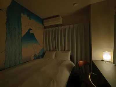 a bedroom with a bed with a map on the wall at The Nest Koenji Cozy Stay near Station Easy Access to Shinjuku in Tokyo
