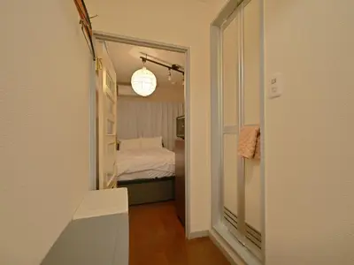 a small bedroom with a bed and a mirror at The Nest Koenji Cozy Stay near Station Easy Access to Shinjuku in Tokyo