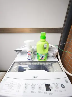 a washing machine with two bottles of detergent on top of it at The Nest Koenji Cozy Stay near Station Easy Access to Shinjuku in Tokyo