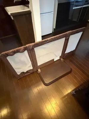 an empty suitcase sitting on a wooden floor at En House Asakusa in Tokyo