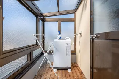 a water heater in a room with a window at Great location 8 minutes on foot from Higashi-Shinjuku Station and 1 stop from Shinjuku Station! Accommodates up to 11 people Wi-Fi available Shibuya, Asakusa, Ikebukuro in Tokyo