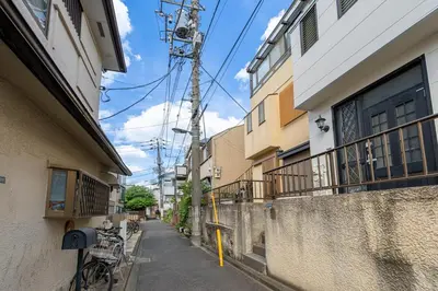 an alley way with a fence and a building at Great location 8 minutes on foot from Higashi-Shinjuku Station and 1 stop from Shinjuku Station! Accommodates up to 11 people Wi-Fi available Shibuya, Asakusa, Ikebukuro in Tokyo