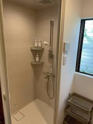 a shower in a bathroom with a glass door at Great location 8 minutes on foot from Higashi-Shinjuku Station and 1 stop from Shinjuku Station! Accommodates up to 11 people Wi-Fi available Shibuya, Asakusa, Ikebukuro in Tokyo
